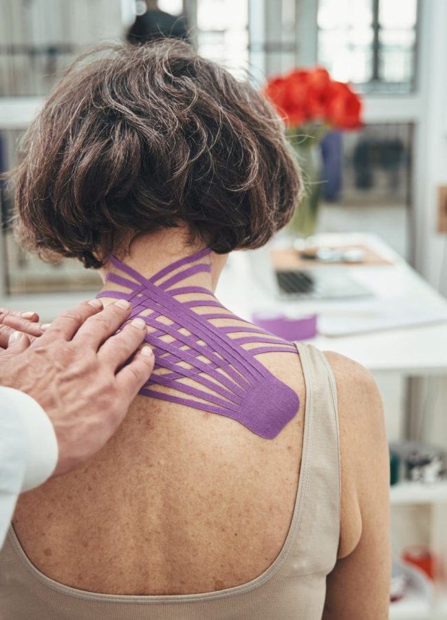male-doctor-using-the-kinesiology-taping-technique-2023-11-27-05-07-08-utc